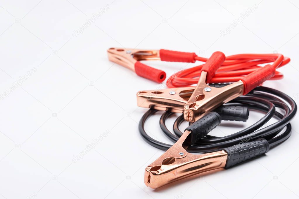 Two jumper cables for car battery isolated on white background.