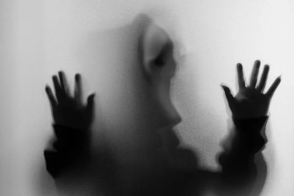 Shadow blur of horror man in screaming mask and hand touches the — Stock Photo, Image