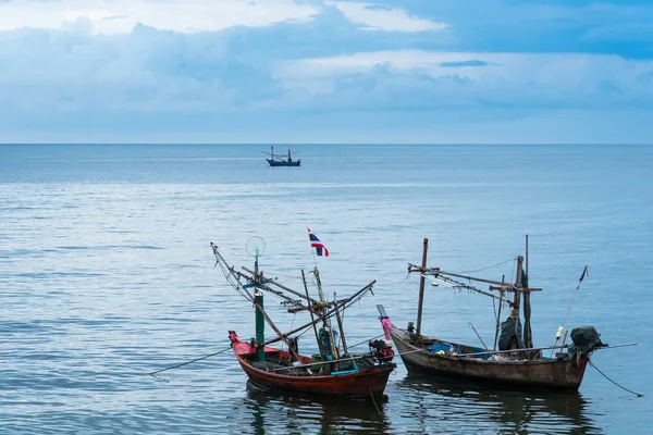 Fishing boats floating in the sea over cloudy sky at Prachuap Kh