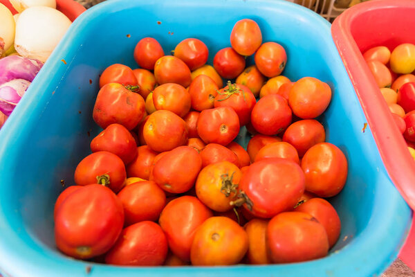 Tomato displayed in baskets and ready for sales in fresh market.