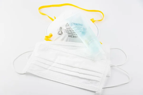 Surgical Face Mask and Alcohol gel to wash hands. Coronavirus Concept. Medical Face Mask For Stopping The Spread of Virus. Surgical mask with rubber ear straps. surgical mask to cover the mouth nose.
