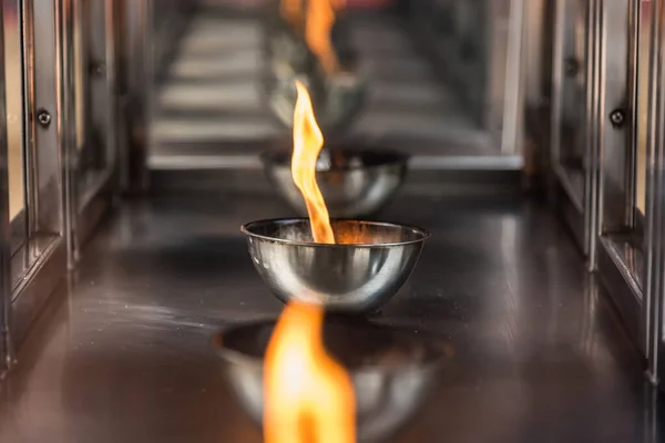 Candle flame on the lantern in Chinese temple.Thailand.