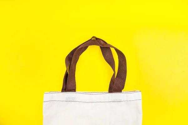 Cloth bag shopping bag isolated on yellow background.Stop using plastic bags.