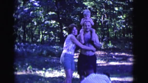 Man and woman with kid standing on yard — Stock Video