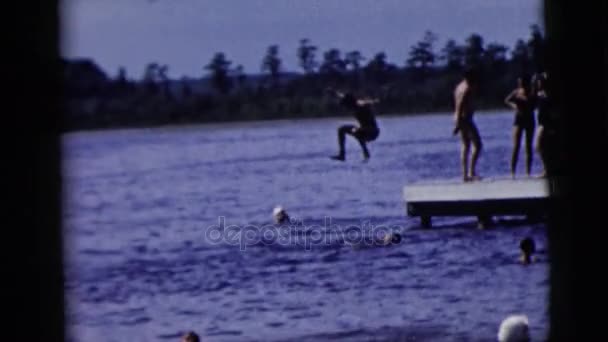 Kid jumping from pier — Stock Video