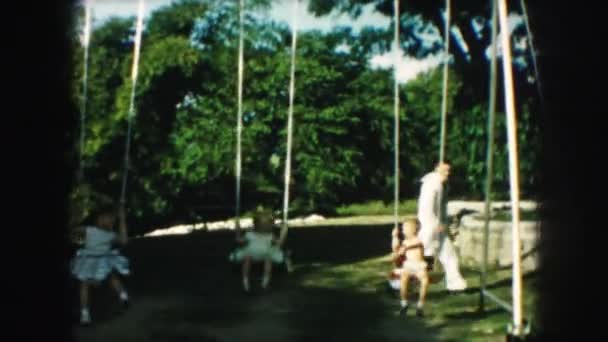 Kids swinging on teeter-totters — Stock Video