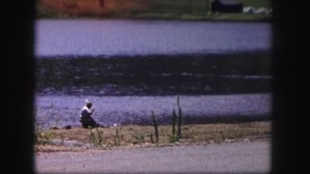 Man on fishing in mountain lake — Stock Video