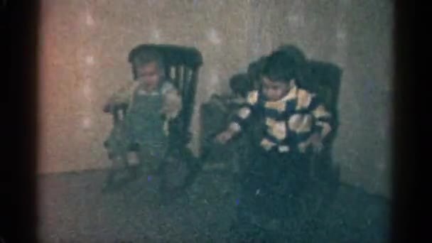 Small kid sitting in rocking chairs — Stock Video