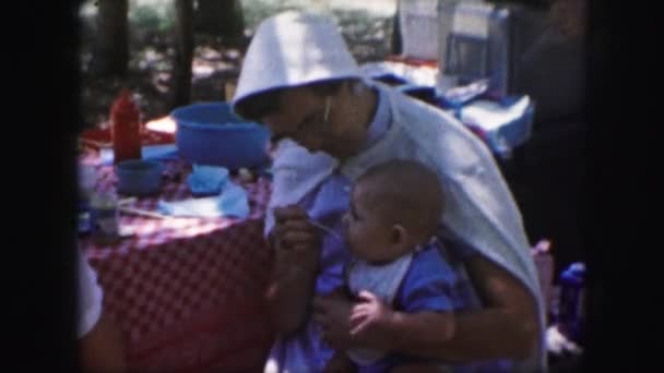 Woman feeding baby with spoon — Stock Video