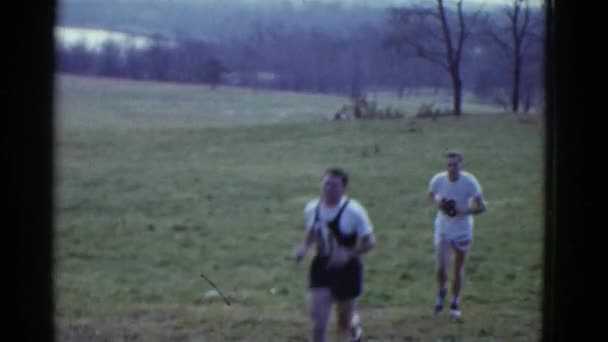 Sporty men jogging on field — Stock Video