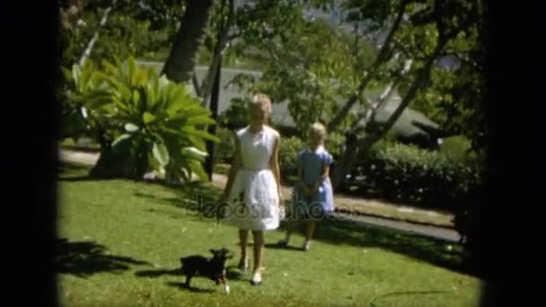 Girls with dog walking in garden — Stock Video