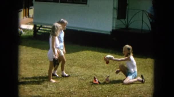 Girls playing with hamster in yard — Stock Video