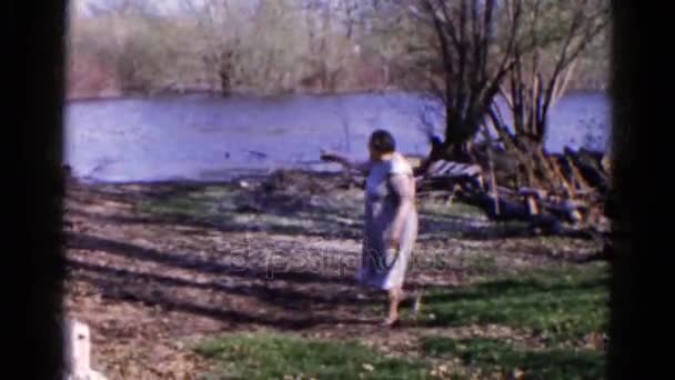 Uma mulher mostra a área perto de um lago — Vídeo de Stock