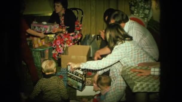 Люди на дивані, обміну та відкриття різдвяні подарунки — стокове відео