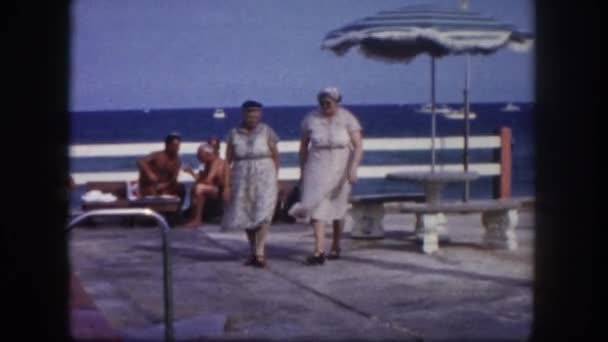 Two senior women walking near pool — Stock Video