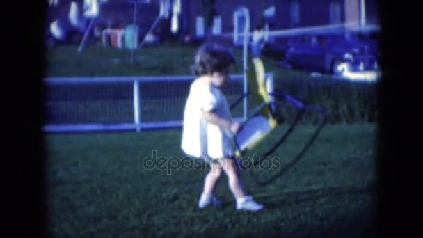 Girl placing chair on field — Stock Video