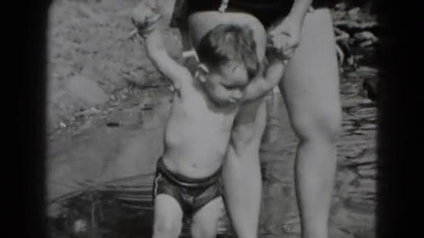 Woman and boy playing at pool — Stock Video