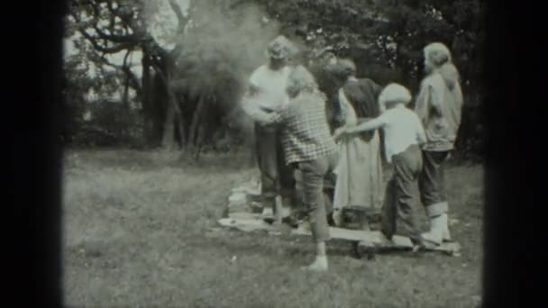 Mensen spelen in de buurt van brazier — Stockvideo