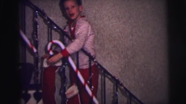 Boy hangs his stocking for santa on christmas eve — Stock Video