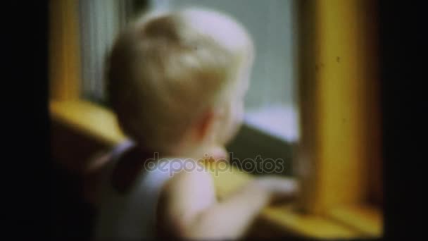 Kind blickt auf Fenster — Stockvideo