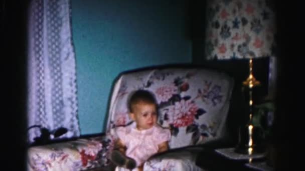 Toddler girl sitting in armchair — Stock Video