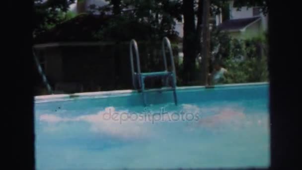 Girl jumping into a swimming pool — Stock Video