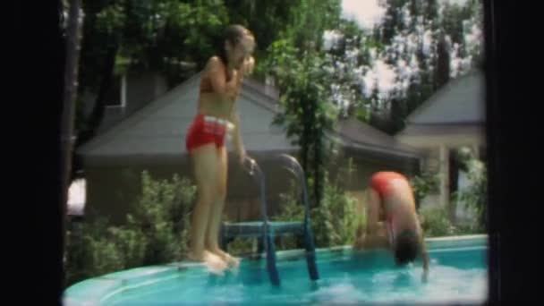 Girls diving into backyard pool — Stock Video