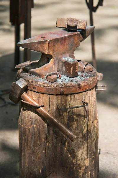 blacksmith anvil with the tools on the barrel, close-up