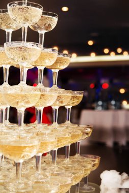 champagne glasses standing in a tower at the party clipart