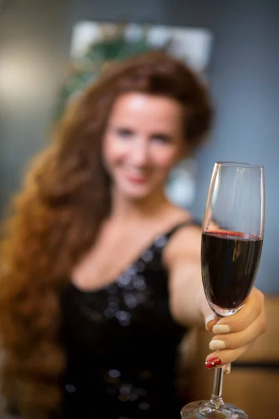 Bir Kadeh Kırmızı Şarap Ile Şenlikli Kıyafetleri Içindeki Güzel Genç — Stok fotoğraf