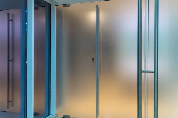 doors in a man\'s toilet from frosted glass