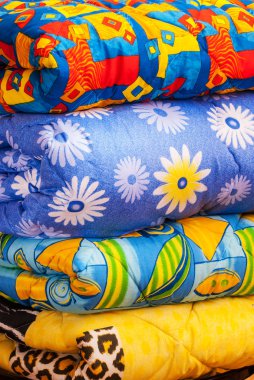 Blankets rolls and pillows on the bed clipart