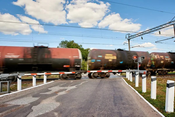 Rides a train, railway crossing. Motion blur.