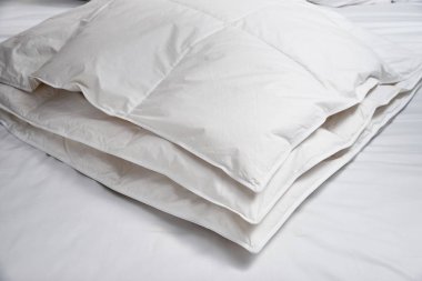 White blanket (quilt) on the bed clipart