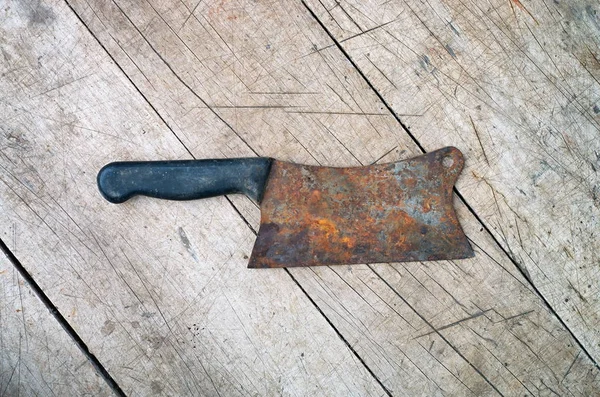 old ax for meat on a wooden background