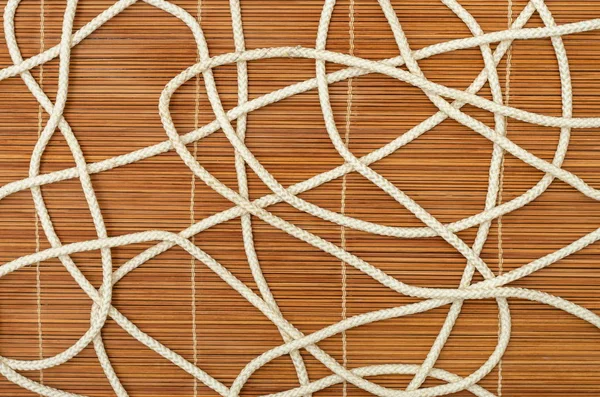 Tangled rope, on a wooden background — Stock Photo, Image