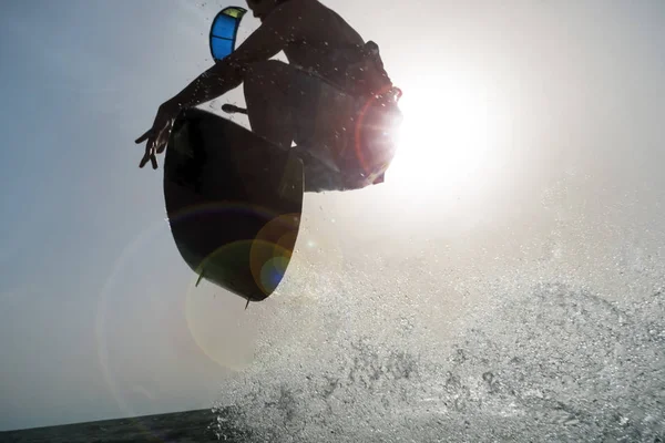 Backlighting of a Surfer jumping at sunset — Stock Photo, Image