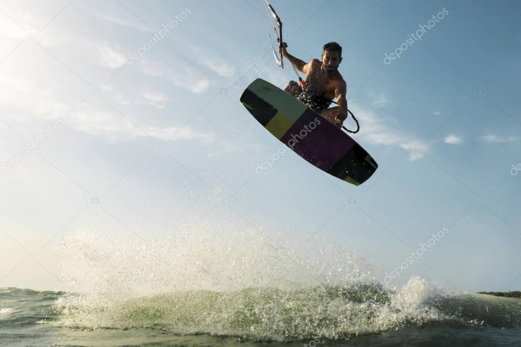 Surfer jumping in front of the camera