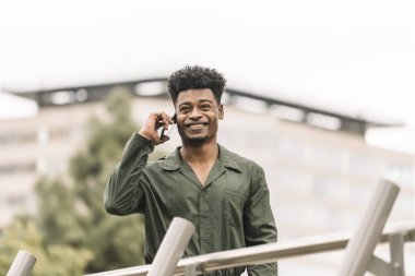 black man calling with the smartphone in the city