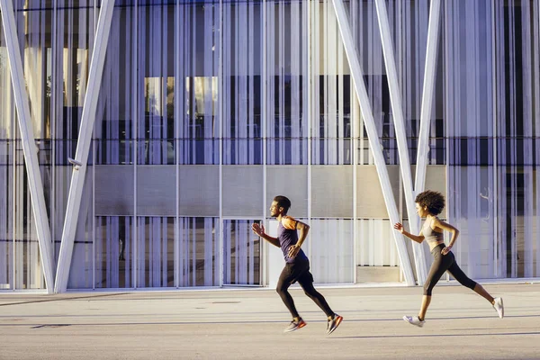 athletic latin woman and sports man running fast