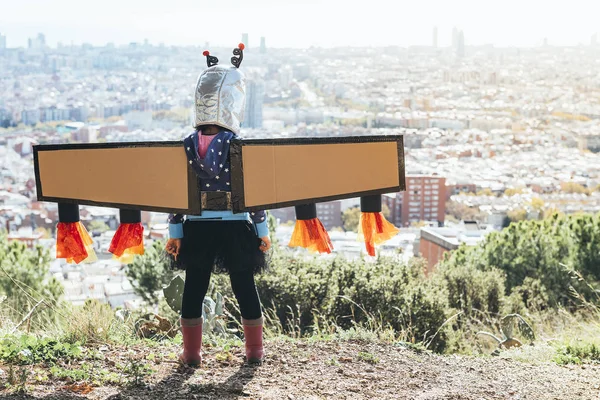 Fille avec costume de super-héros regardant le paysage urbain — Photo