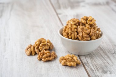 Tahta masadaki beyaz kasede ceviz