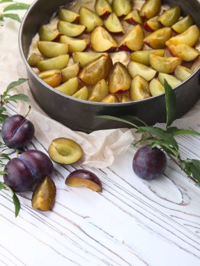 Ahşap bir arka plan üzerinde pişirme önce Erik ile pasta