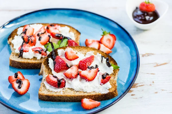 Snack from Wholemeal Bread Toasts, Ricotta cheese and Strawberri