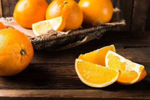 Frische reife Orangen und Orangenscheiben — Stockfoto