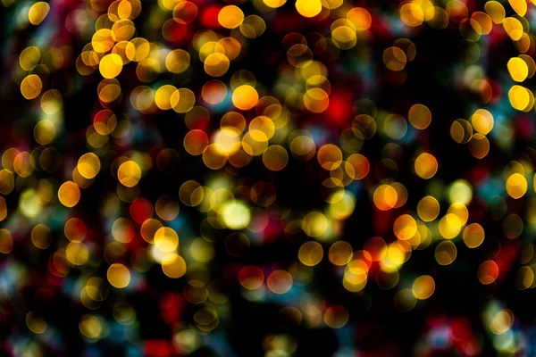 Bokeh abstracto hecho de luces de Navidad en la tienda sobre fondo negro — Foto de Stock