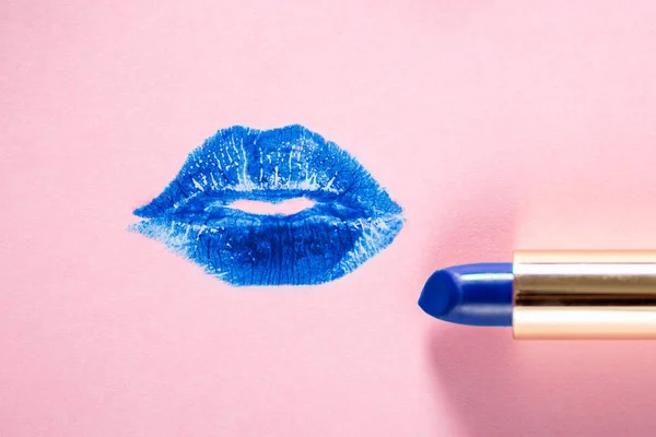 Blue lipstick stains as lips with lipstick nearby