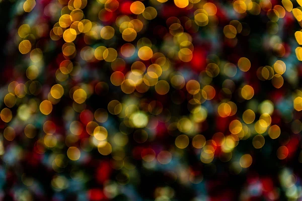 Bokeh abstracto hecho de luces de Navidad en la tienda sobre fondo negro — Foto de Stock
