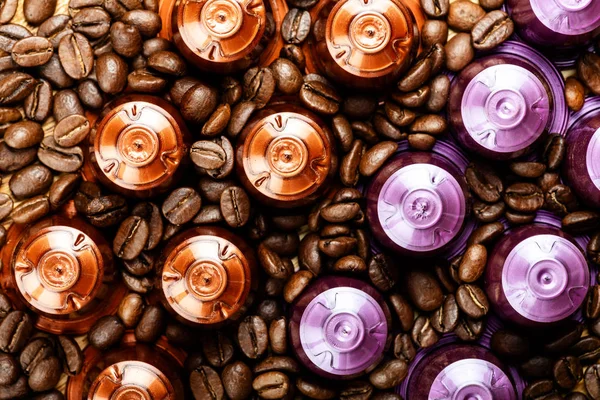 Caffè espresso capsule o cialde e chicchi di caffè su sfondo rustico in legno — Foto Stock