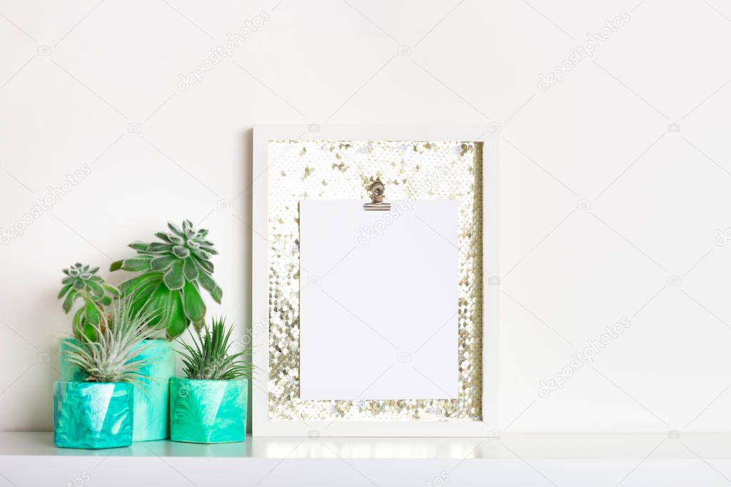 Lifestyle home decoration with frame with place for text and succulents